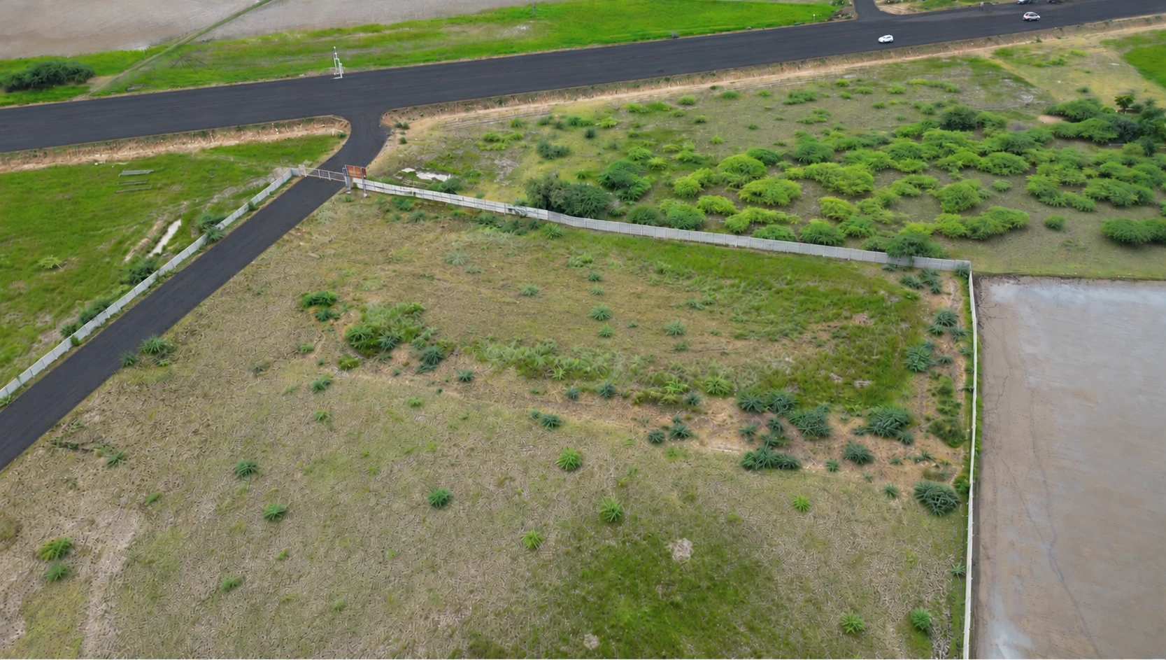 A wide aerial view of Global City 2 grounds, boundary and highway-side entrance