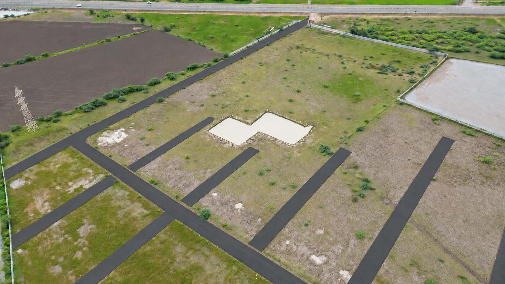 An aerial view of Global City 2 roads, open grounds and the nearby highway