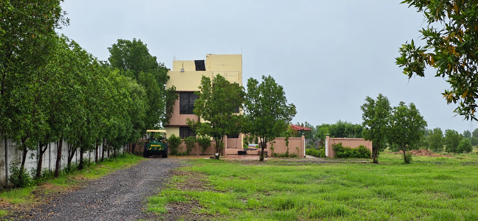 Green grounds, a gravel pathway and a building within the Global City site