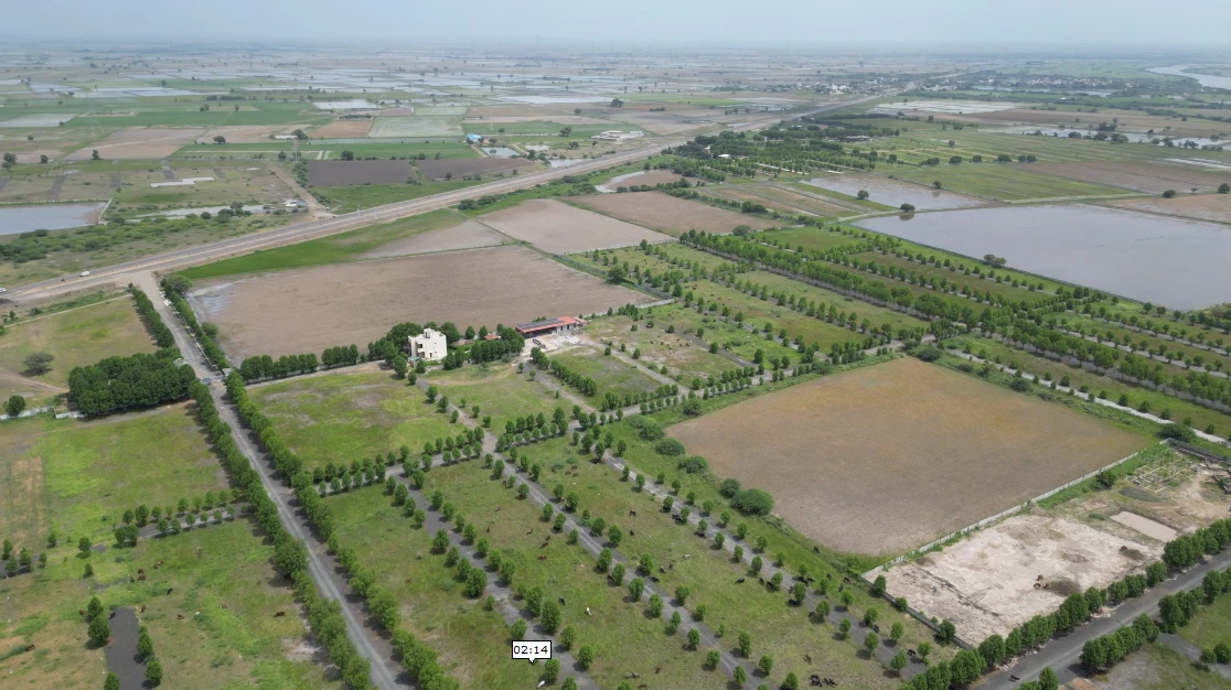 Actual aerial site photograph showing internal roads and the nearby highway